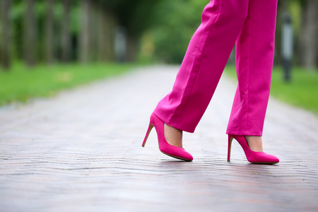 Young woman in stylish high-heeled shoes walking outdoorsの写真素材