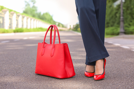 Young woman in stylish shoes and with bag outdoorsの写真素材