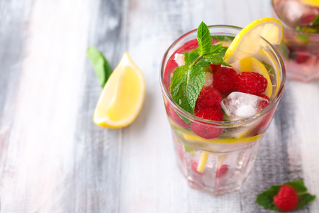 Glass of fresh raspberry mojito on wooden tableの写真素材