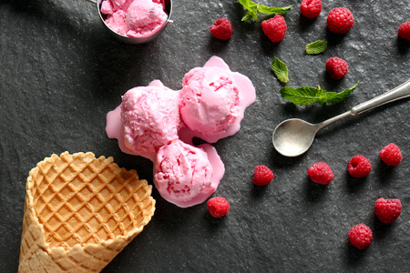 Composition with tasty raspberry ice-cream on slate plate