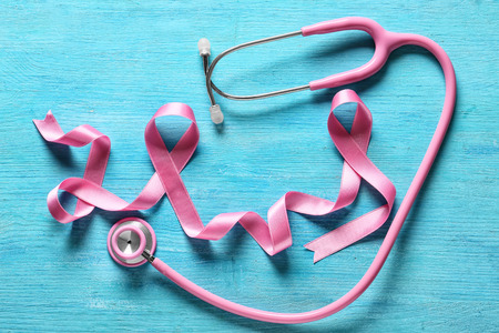 Pink ribbon and stethoscope on color background. Breast cancer awareness conceptの写真素材