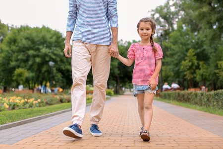 Little girl and her father walking outdoorsの写真素材