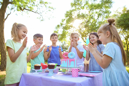 Cute little children celebrating Birthday outdoorsの写真素材