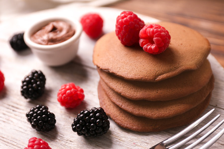 Tasty chocolate pancakes on wooden stand, closeupの写真素材