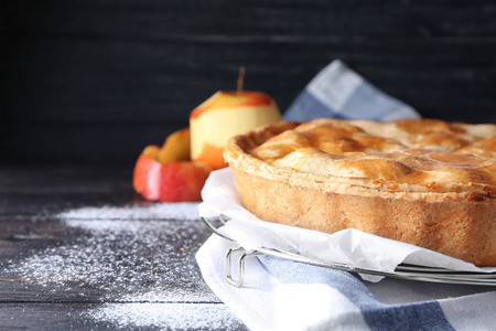 Cooling rack with delicious apple pie on wooden table, closeupの写真素材
