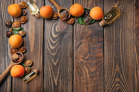 Composition with apricot essential oil on wooden backgroundの写真素材