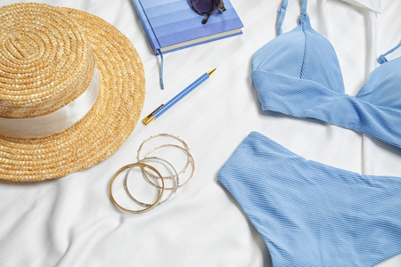 Composition with swimming suit and accessories on bed linenの写真素材