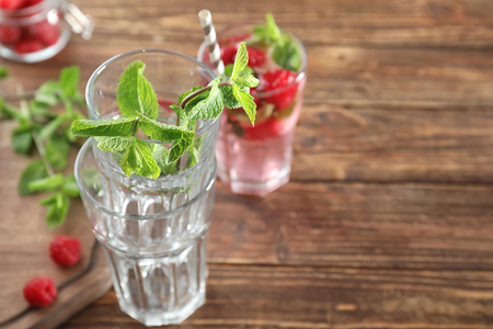 Empty glasses with mint leaves on wooden tableの写真素材