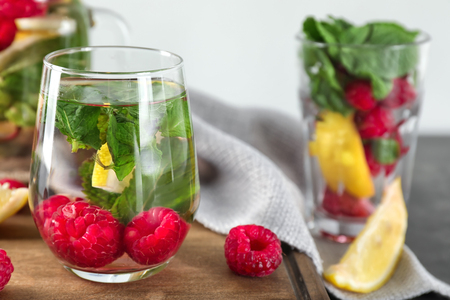 Glass of fresh raspberry mojito on board, closeupの写真素材