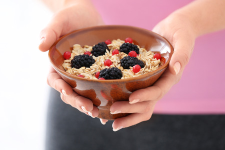 Woman with bowl of tasty oatmeal, closeupの写真素材
