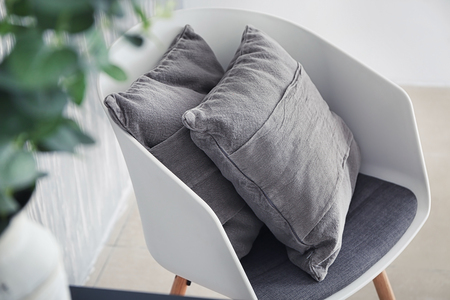 Armchair with soft pillows indoorsの写真素材
