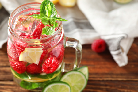 Mason jar of fresh raspberry mojito on wooden table, closeupの写真素材