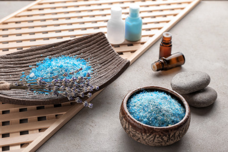 Sea salt for spa, essential oil and lavender on tableの写真素材