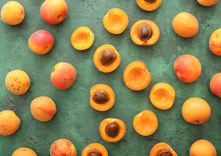 Ripe sweet apricots on color table, top viewの写真素材