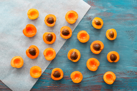 Ripe sweet apricots on wooden table, top viewの写真素材