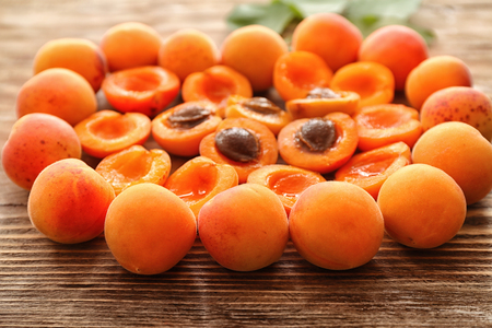 Ripe sweet apricots on wooden tableの写真素材
