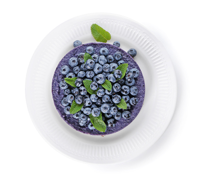 Plate with delicious blueberry cheesecake on white background, top viewの写真素材