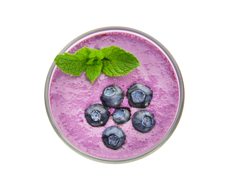 Glass of tasty blueberry smoothie on white background, top viewの写真素材
