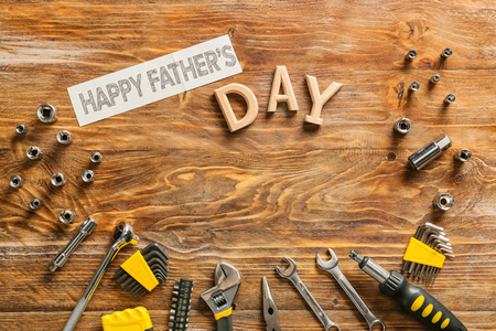 Different tools and text "Happy Father's Day" on wooden backgroundの写真素材