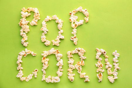 Words made of delicious popcorn on color backgroundの写真素材