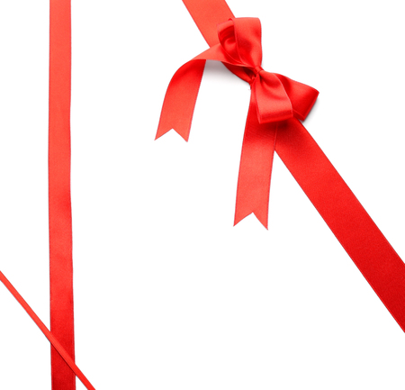Red ribbons with bow on white backgroundの写真素材