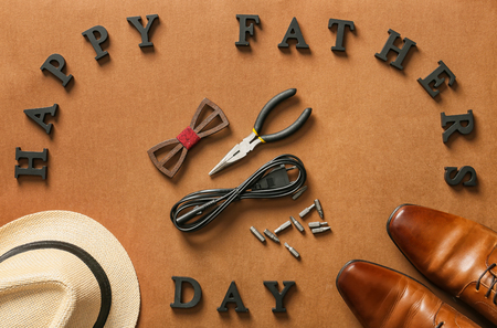 Male accessories, tools and letters forming text "Happy Father's Day" on color backgroundの写真素材
