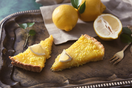 Pieces of tasty lemon pie on metal trayの写真素材