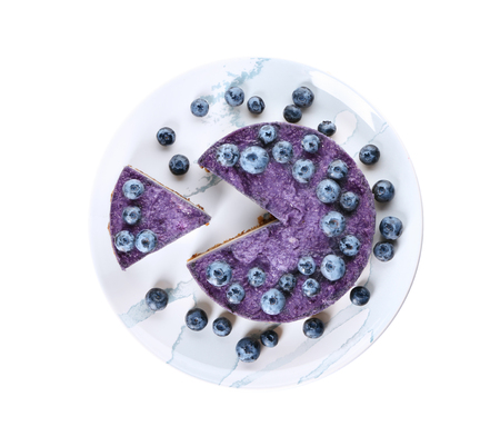 Plate with tasty blueberry cheesecake on white backgroundの写真素材