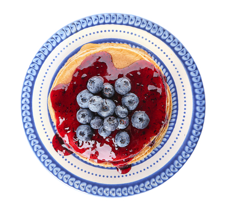 Plate with tasty pancakes, jam and blueberries on white backgroundの写真素材