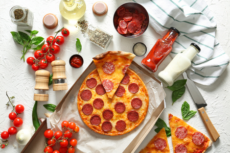 Composition with tasty Pepperoni pizza and ingredients on tableの写真素材