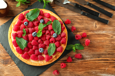Delicious raspberry cheesecake on wooden tableの写真素材