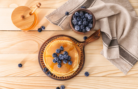 Composition with tasty pancakes and blueberries on wooden tableの写真素材