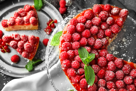 Delicious raspberry cheesecake on dessert stand, top viewの写真素材