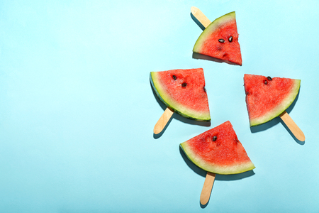 Delicious sliced watermelon on color backgroundの写真素材