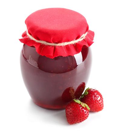 Glass jar with delicious strawberry jam on white backgroundの写真素材