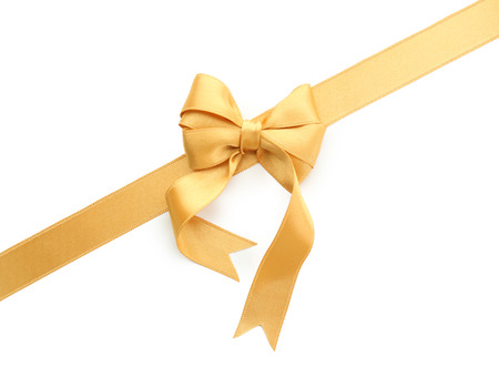Golden ribbon with bow on white backgroundの写真素材