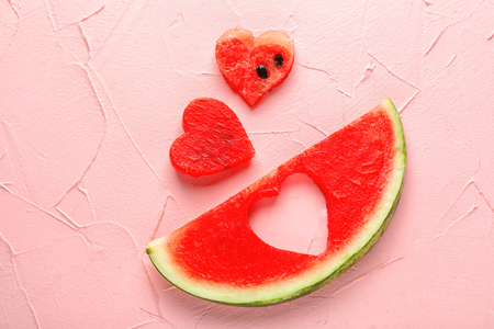 Creative composition with delicious sliced watermelon on color backgroundの写真素材