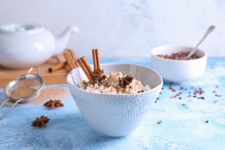 Bowl with delicious rice pudding and cinnamon powder on light tableの写真素材