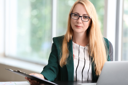 Stylish businesswoman working in officeの写真素材