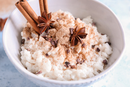 Bowl with delicious rice pudding and cinnamon powder, closeupの写真素材