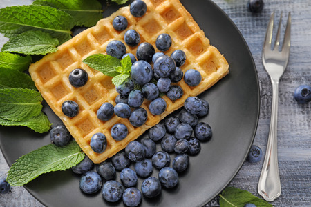 Delicious waffle with blueberries on plateの写真素材