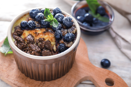 Bowl with delicious blueberry pudding on board, closeupの写真素材