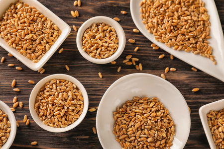 Composition with raw wheat on wooden tableの写真素材