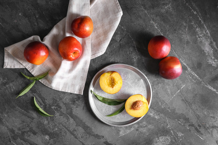 Plate with fresh peaches on tableの写真素材