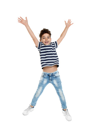 Cute little boy jumping on white backgroundの写真素材