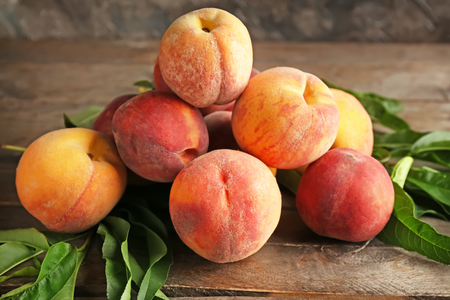 Fresh peaches on wooden tableの写真素材