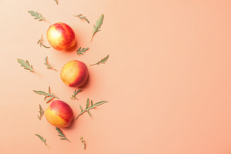 Composition with ripe peaches on color background, top viewの写真素材