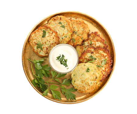 Metal tray with zucchini pancakes and sauce isolated on whiteの写真素材