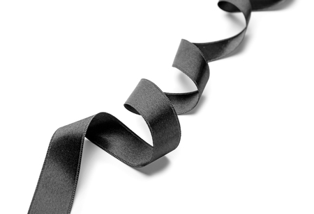 Curled black ribbon on white backgroundの写真素材