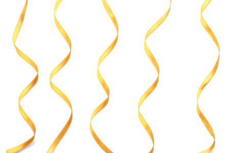 Golden satin ribbons on white backgroundの写真素材